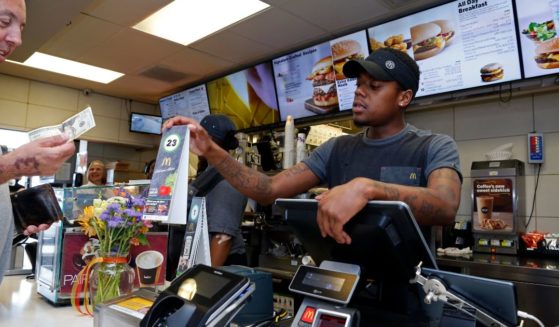 A customer pays for his order at a McDonald's restaurant in Pittsburgh Wednesday, July 18, 2018. (Gene J. Puskar / Associated Press)