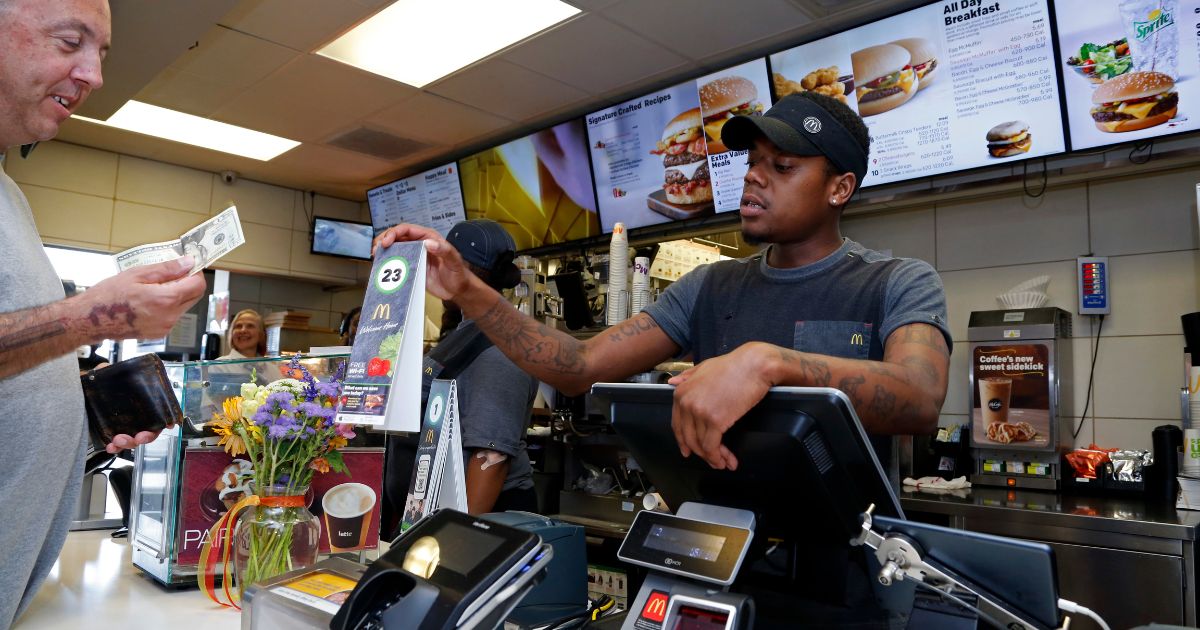 A customer pays for his order at a McDonald's restaurant in Pittsburgh Wednesday, July 18, 2018. (Gene J. Puskar / Associated Press)