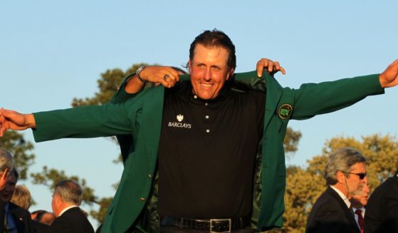 Phil Mickelson is presented with the green jacket for winning the 2010 Masters Tournament in Augusta, Georgia, on April 11, 2010.