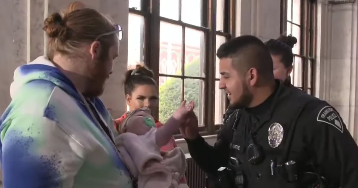 Officer Freddy Martinez greets the family he helped save during an April 3 house fire.