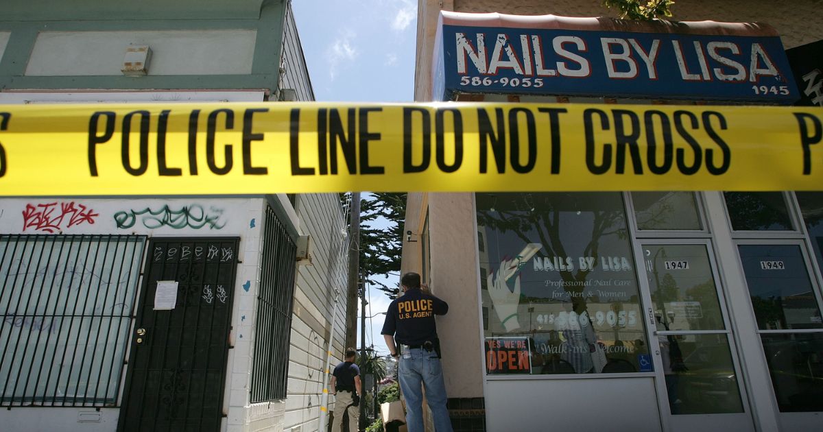 Federal law enforcement agents stand guard during a raid of a medicinal marijuana club June 22, 2005, in San Francisco.