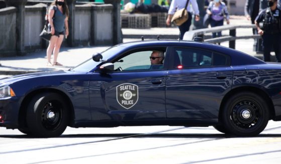 A Seattle Police officer monitors a "Defund the Police" march in Seattle, Washington, on Aug. 5, 2020.