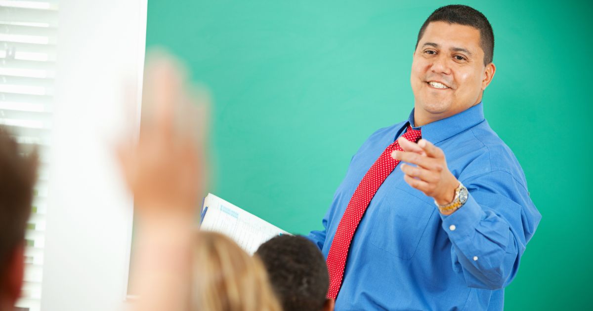 A stock photo shows a teacher calling on a student. (Sean Locke Photography / Shutterstock)