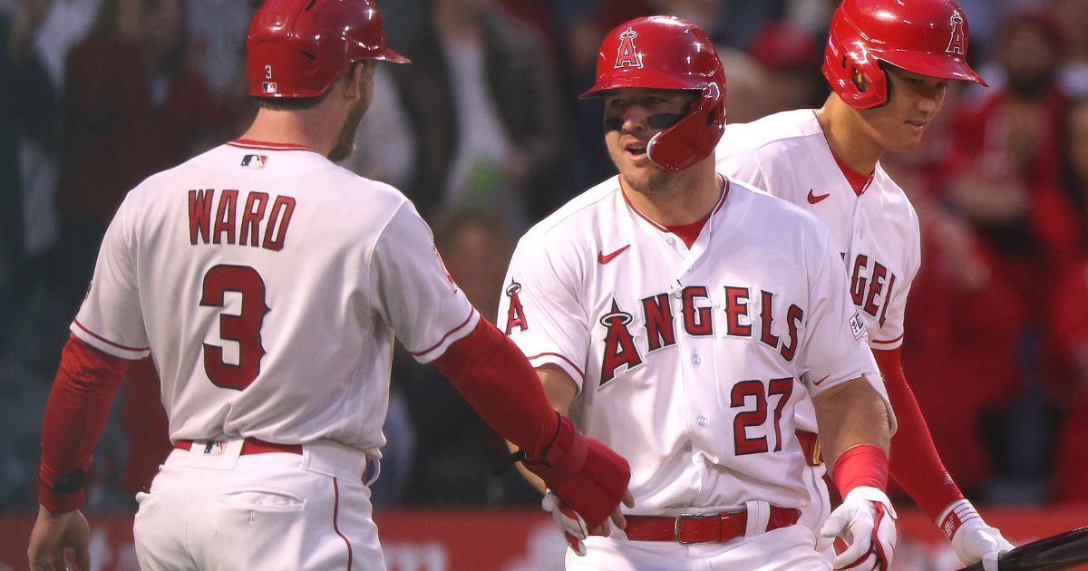 Mike Trout of the Los Angeles Angels, center, celebrates his two-run home run with Taylor Ward, left, and Shohei Ohtani in a game against the Toronto Blue Jays in Anaheim, California, on Friday. The Angels lost 4-3.