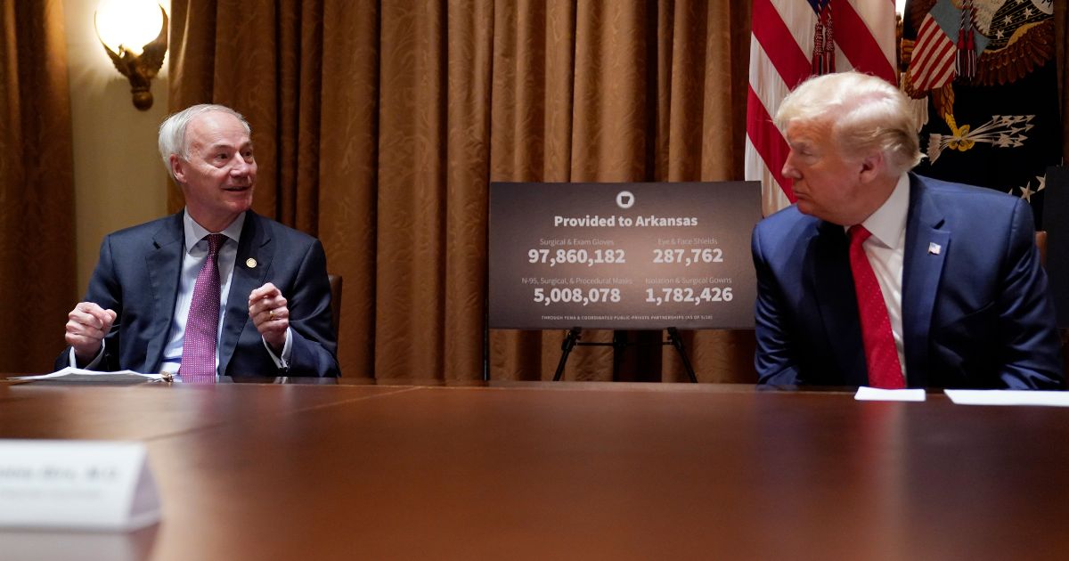 President Donald Trump listens during a meeting with Arkansas Gov. Asa Hutchinson in the Cabinet Room of the White House, Wednesday, May 20, 2020, in Washington. (Evan Vucci / Associated Press)