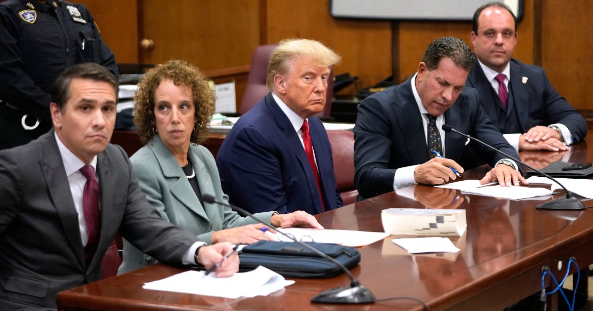 Former President Donald Trump sits with his attorneys inside the courtroom for his arraignment proceeding at Manhattan Criminal Court in New York City on Tuesday.