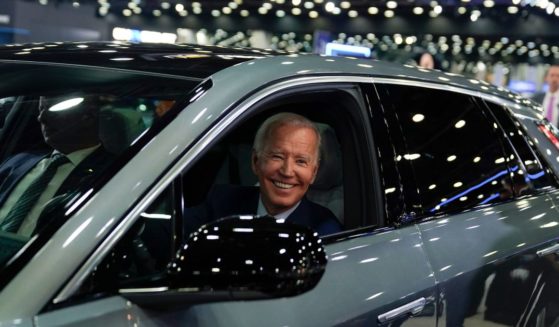 Joe Biden driving a Cadillac Lyriq through the showroom