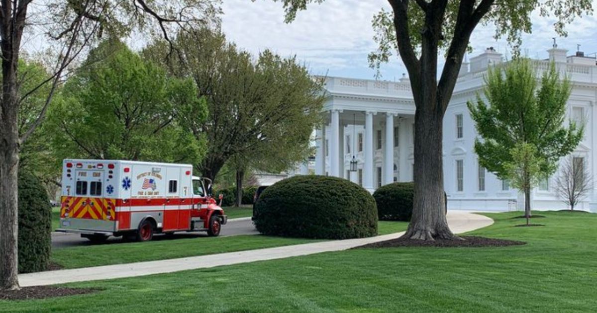 an ambulance sitting in the White House driveway