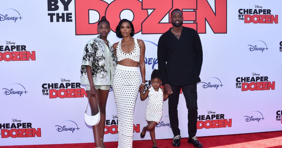 Actress Gabrielle Union (2L) and her husband former professional basketball player Dwayne Wade pose with daughters Zaya Wade (L) and Kaavia James Union Wade (2R) as they arrive for the "Cheaper by the Dozen" Disney premiere at the El Capitan theatre in Hollywood, California, March 16, 2022.