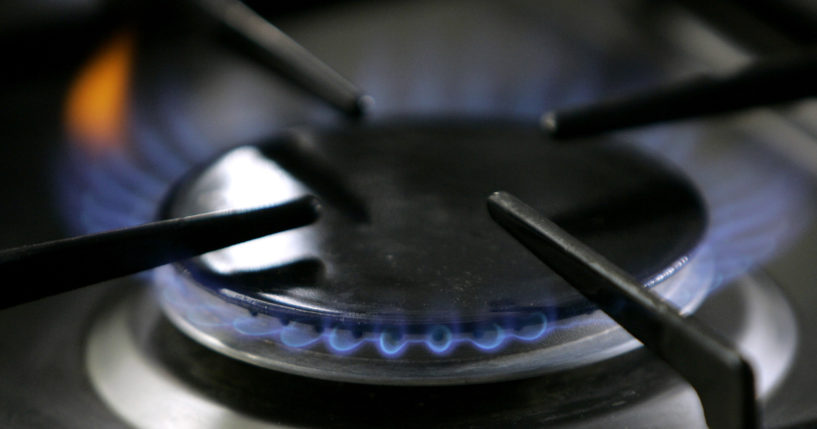 A gas-lit flame is ignited on a natural gas stove.