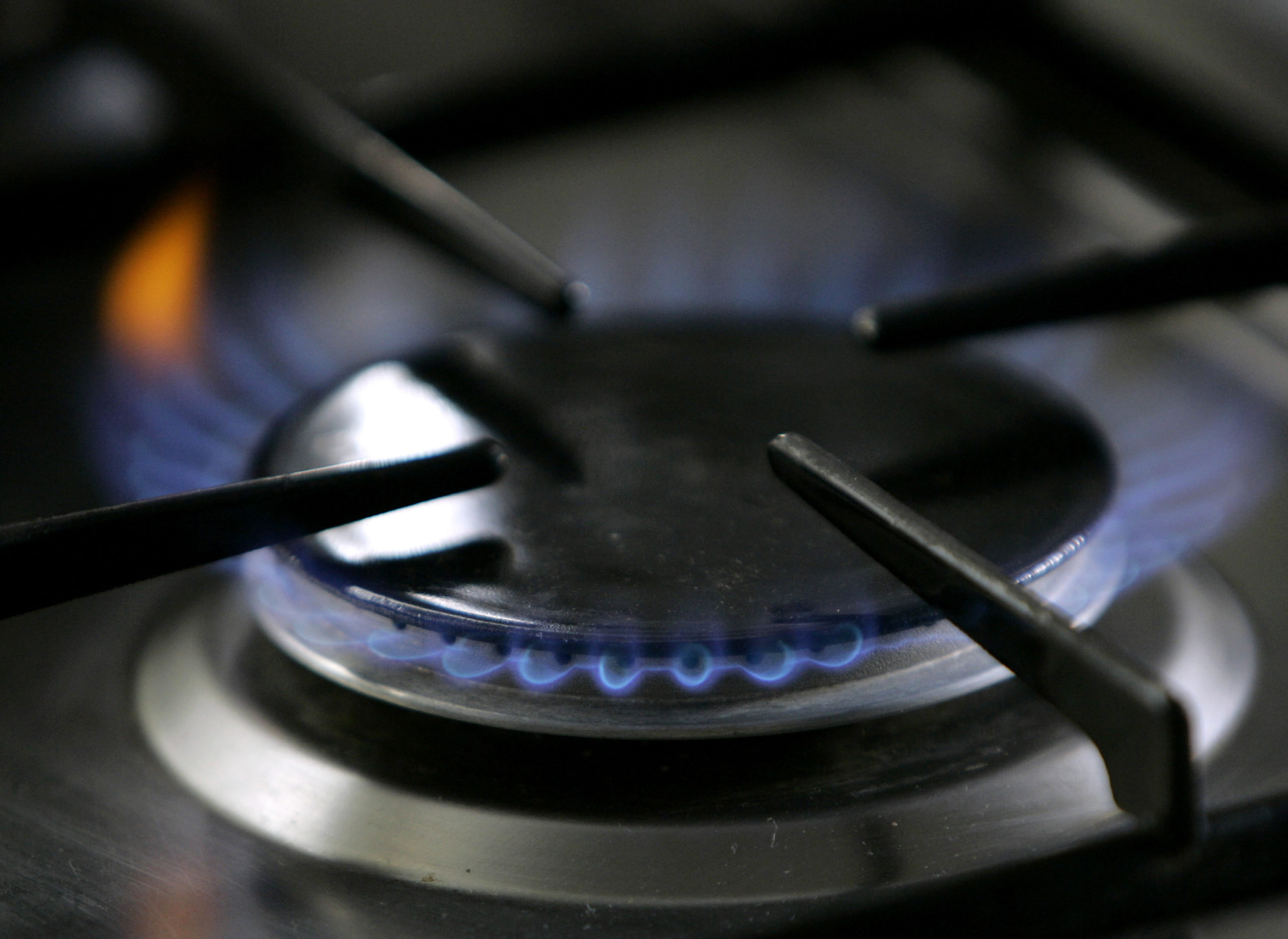 A gas-lit flame is ignited on a natural gas stove.
