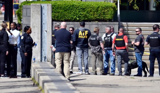 Members of the Louisville Metro Police and federal ATF agents gather outside of the Old National Bank building in Louisville on Monday.