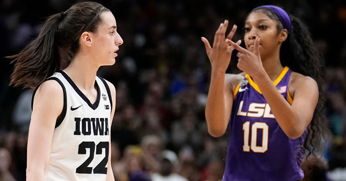LSU's Angel Reese reacts in front of Iowa's Caitlin Clark during the second half of the NCAA Women's Final Four championship basketball game on Sunday in Dallas.