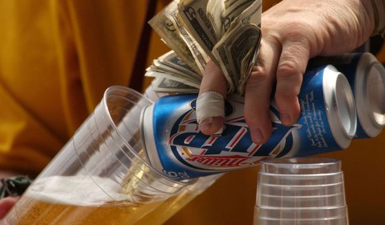 A vendor pours beer for fans during a game between the Chicago White Sox and the Seattle Mariners in a file photo from Sept. 5, 2004, at U.S. Cellular Field in Chicago.