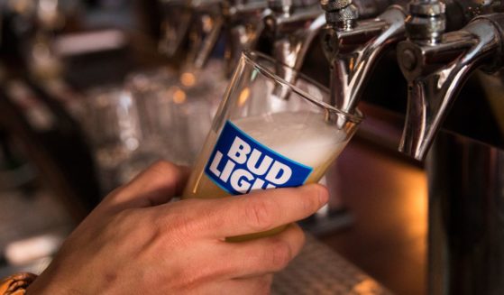 In this photo illustration, a bartender pours a Bud Light from a tap, July 26, 2018, in New York City.
