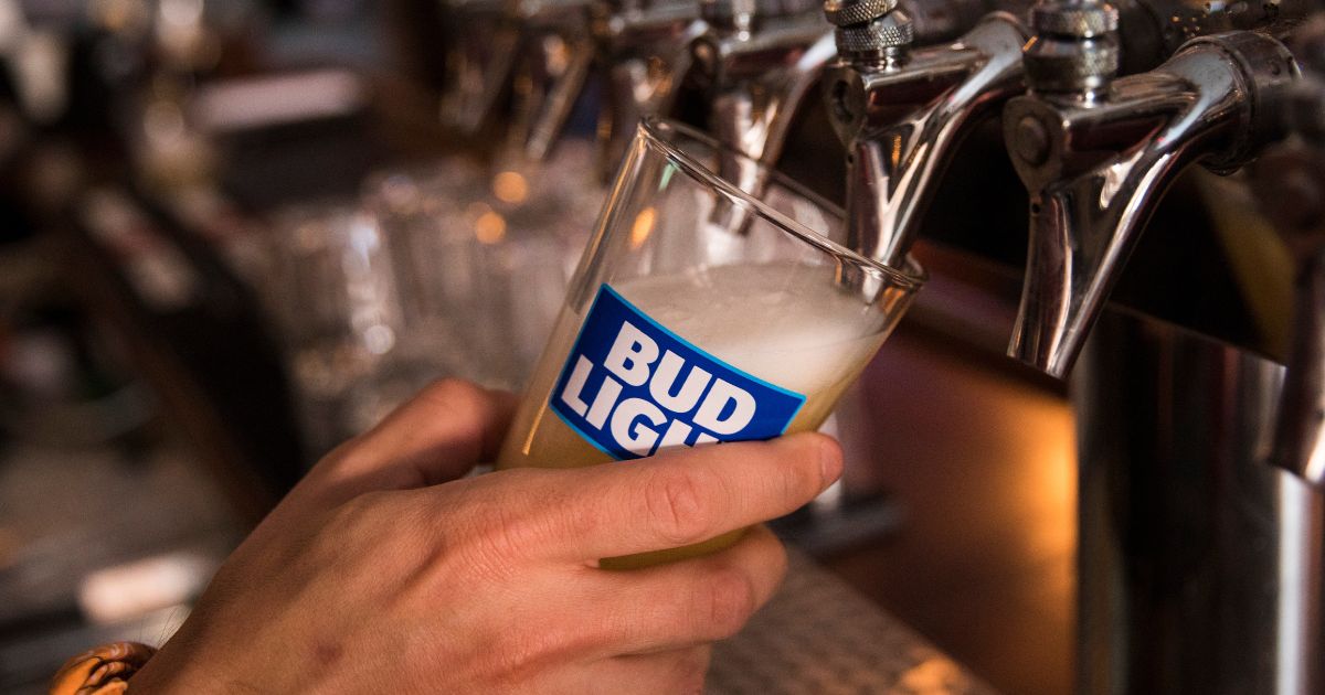 In this photo illustration, a bartender pours a Bud Light from a tap, July 26, 2018, in New York City.