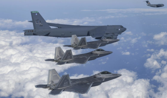 a U.S. B-52 bomber, C-17, and U.S. Air Force F-22 fighter jets flying over the Korean Peninsula