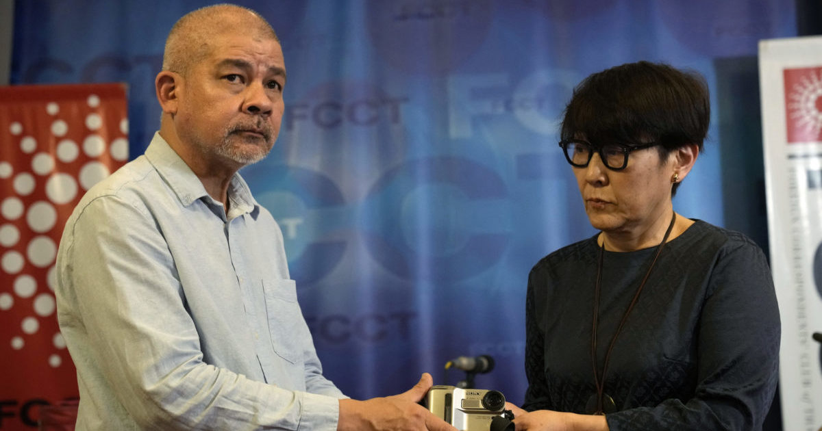 Aye Chan Naing handing the video camera of slain Japanese journalist Kenji Nagai to his sister Noriko Ogawa