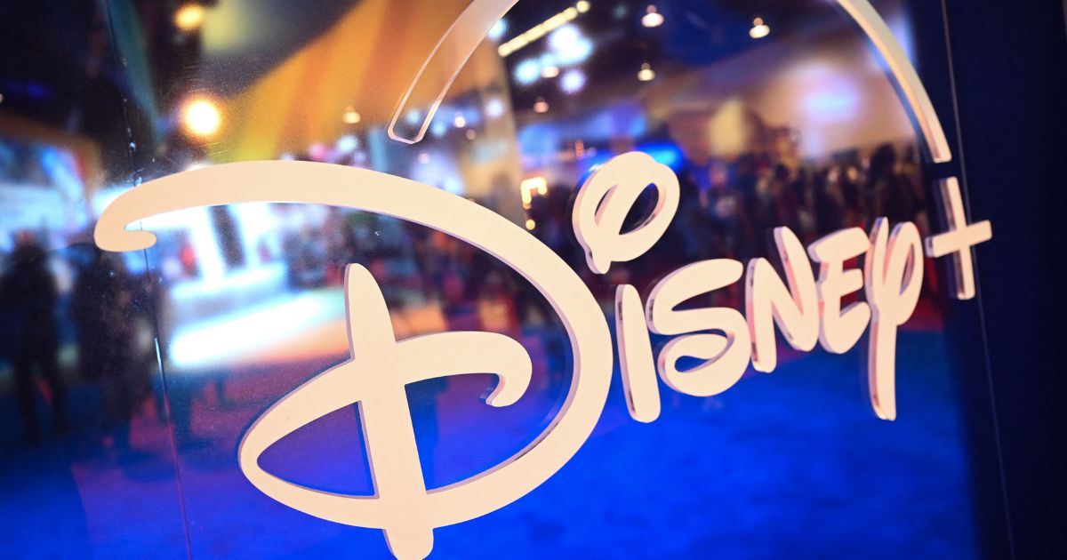 Fans are reflected in Disney+ logo during the Walt Disney D23 Expo in Anaheim, California on Sept. 9, 2022.