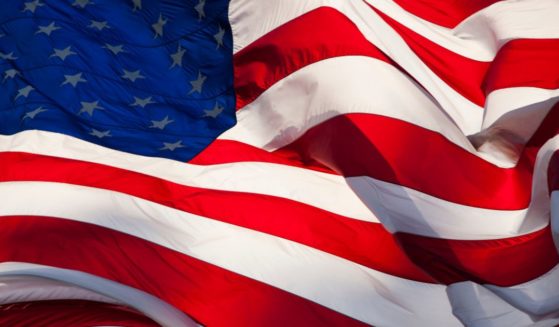 An American flag waves in this stock image.