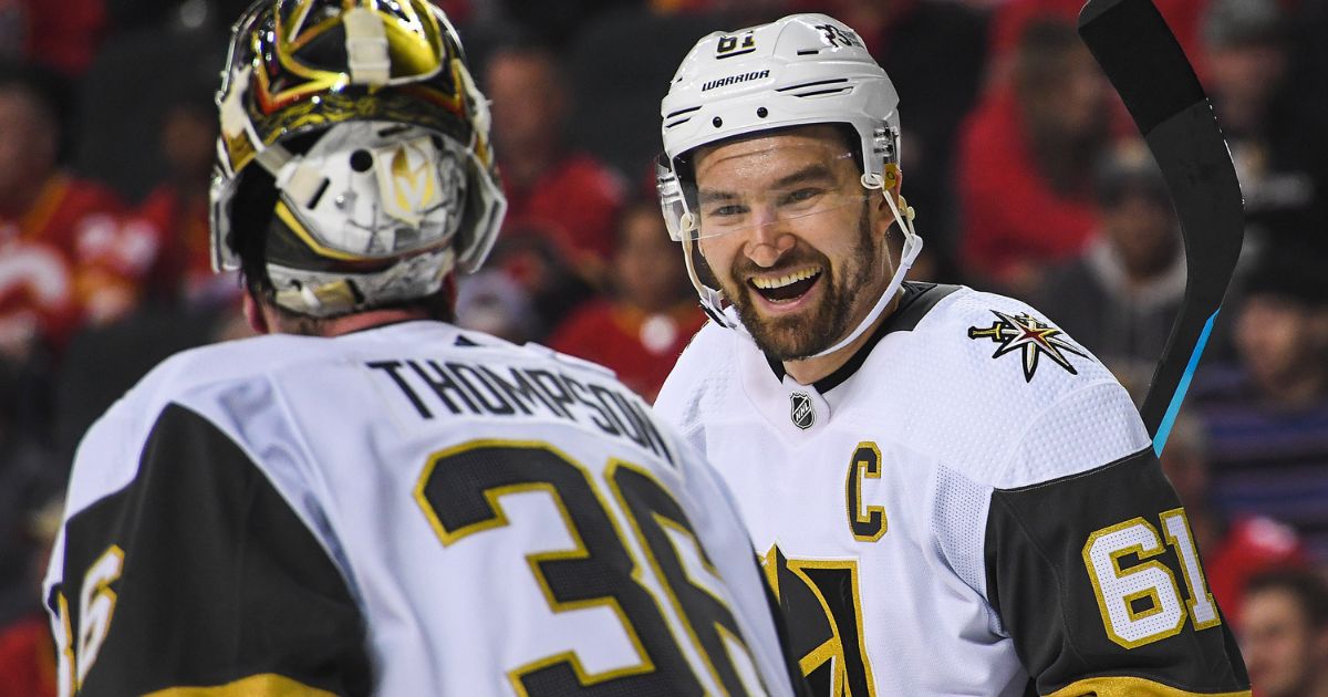 Logan Thompson #36 (L) and Mark Stone #61 of the Vegas Golden Knights laugh during a break in play against the Calgary Flames during the third period of an NHL game at Scotiabank Saddledome on April 14, 2022, in Calgary, Alberta, Canada.