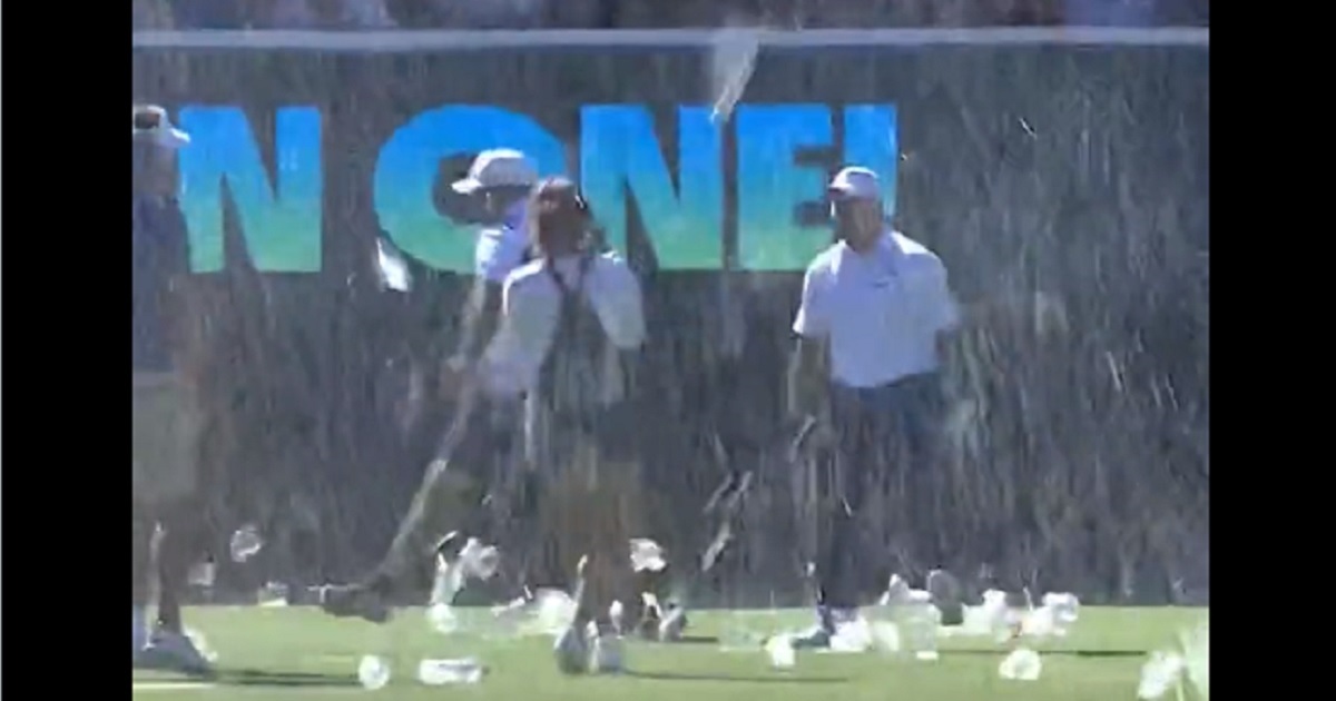 Beer rains down from the stands as fans and golfers celebrate Chase Koepka's hole in one Sunday at The Grange Golf Club in Adelaide, Australia.