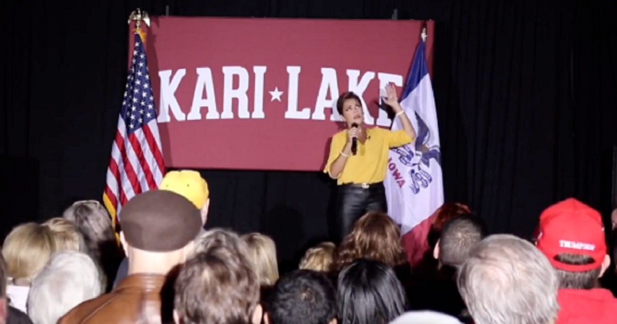 Kari Lake, the Republican who's still challenging the results of Arizona's flawed election for governor in November, is pictured speaking on stage April 7 at the University Iowa in Des Moines.