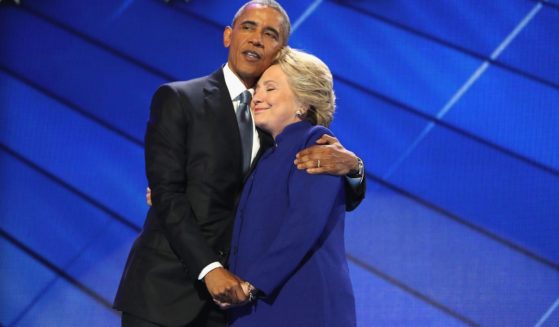 Then-President Barack Obama and Democratic presidential candidate Hillary Clinton embrace on the third day of the Democratic National Convention in Philadelphia on July 27, 2016.
