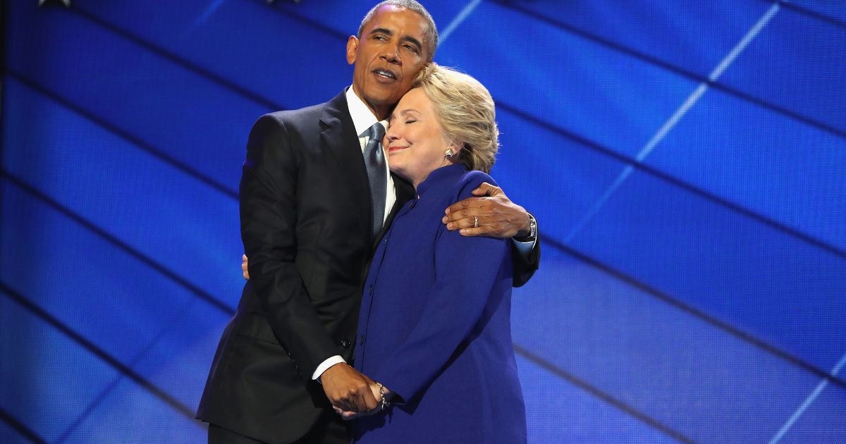 Then-President Barack Obama and Democratic presidential candidate Hillary Clinton embrace on the third day of the Democratic National Convention in Philadelphia on July 27, 2016.