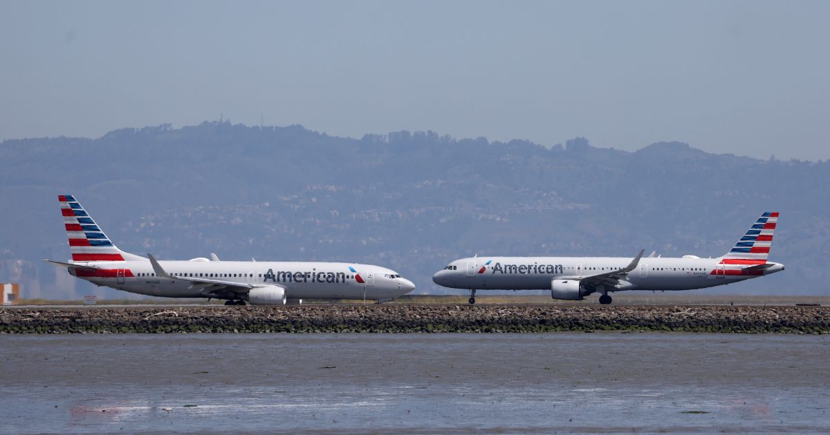 An American Airlines plane prepares to take off past another American Airlines plane on the runway at San Francisco International Airport on April 27, 2023 in San Francisco.