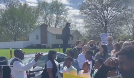 Protesters are seen in Kansas City, Missouri, on Sunday after a 16-year-old was shot.