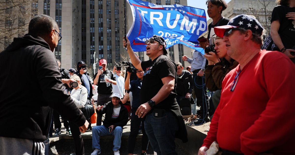 Supporters and opponents of former President Donald Trump gather outside the Manhattan Criminal Court during his arraignment on Tuesday in New York City.
