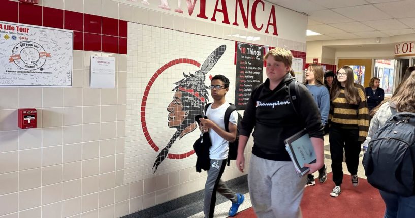 Students walk past a logo that is tiled into the wall at Salamanca High School in Salamanca, New York, on April 18.