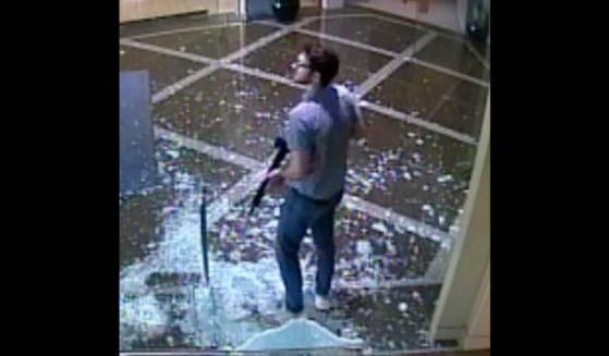 This surveillance image shows Connor Sturgeon carrying a rifle after opening fire at Old National Bank in Louisville, Kentucky, on April 10.