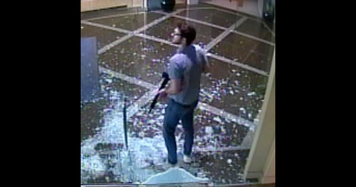 This surveillance image shows Connor Sturgeon carrying a rifle after opening fire at Old National Bank in Louisville, Kentucky, on April 10.
