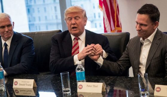 Then Vice President-elect Mike Pence looks on as then President-elect Donald Trump shakes the hand of Peter Thiel during a meeting with technology executives at Trump Tower, Dec. 14, 2016, in New York City.