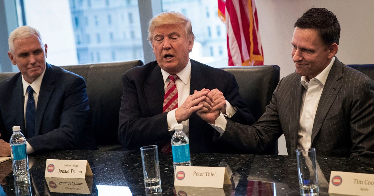 Then Vice President-elect Mike Pence looks on as then President-elect Donald Trump shakes the hand of Peter Thiel during a meeting with technology executives at Trump Tower, Dec. 14, 2016, in New York City.