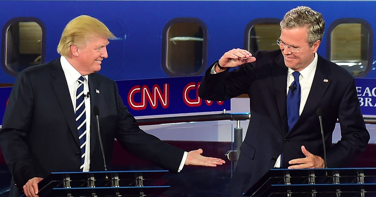 Donald Trump and Jeb Bush high five during the Republican Presidential Debate at the Ronald Reagan Presidential Library in Simi Valley, California on September 16, 2015.
