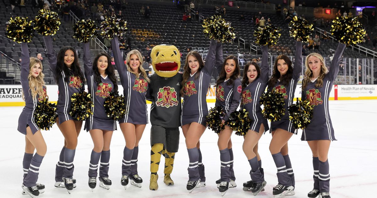 The Vegas Golden Knights mascot Chance the Golden Gila Monster and members of the Knights Guard, wearing specialty jerseys for the Vegas Golden Knights' Women's History Knight celebrating Women's History Month, pose on the ice after the team's 3-2 victory over the Carolina Hurricanes at T-Mobile Arena on March 1, 2023 in Las Vegas.
