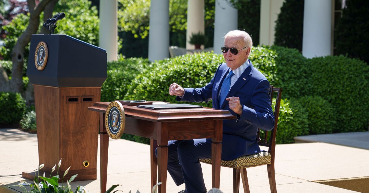 Joe Biden remarks that the desk is hot from the sun before signing an executive order that would create the White House Office of Environmental Justice, in the Rose Garden of the White House April 21, 2023 in Washington, DC.