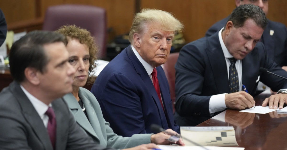 Former President Donald Trump sits at the defense table with his legal team in a Manhattan court