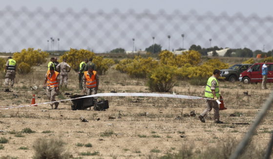 Emergency service members work in the area where an F-18 fighter jet crashed in Zaragoza, Spain, Saturday, May 20, 2023.