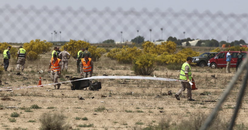 Emergency service members work in the area where an F-18 fighter jet crashed in Zaragoza, Spain, Saturday, May 20, 2023.