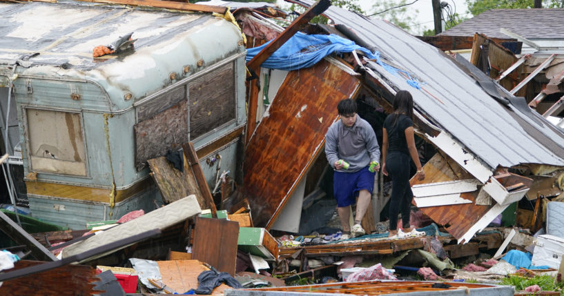 A person stands outside of a damaged home after a tornado hit on Saturday in Laguna Heights, Texas, near South Padre Island. Authorities say one person was killed and several were injured when the tornado struck the southernmost tip of Texas on the Gulf Coast.