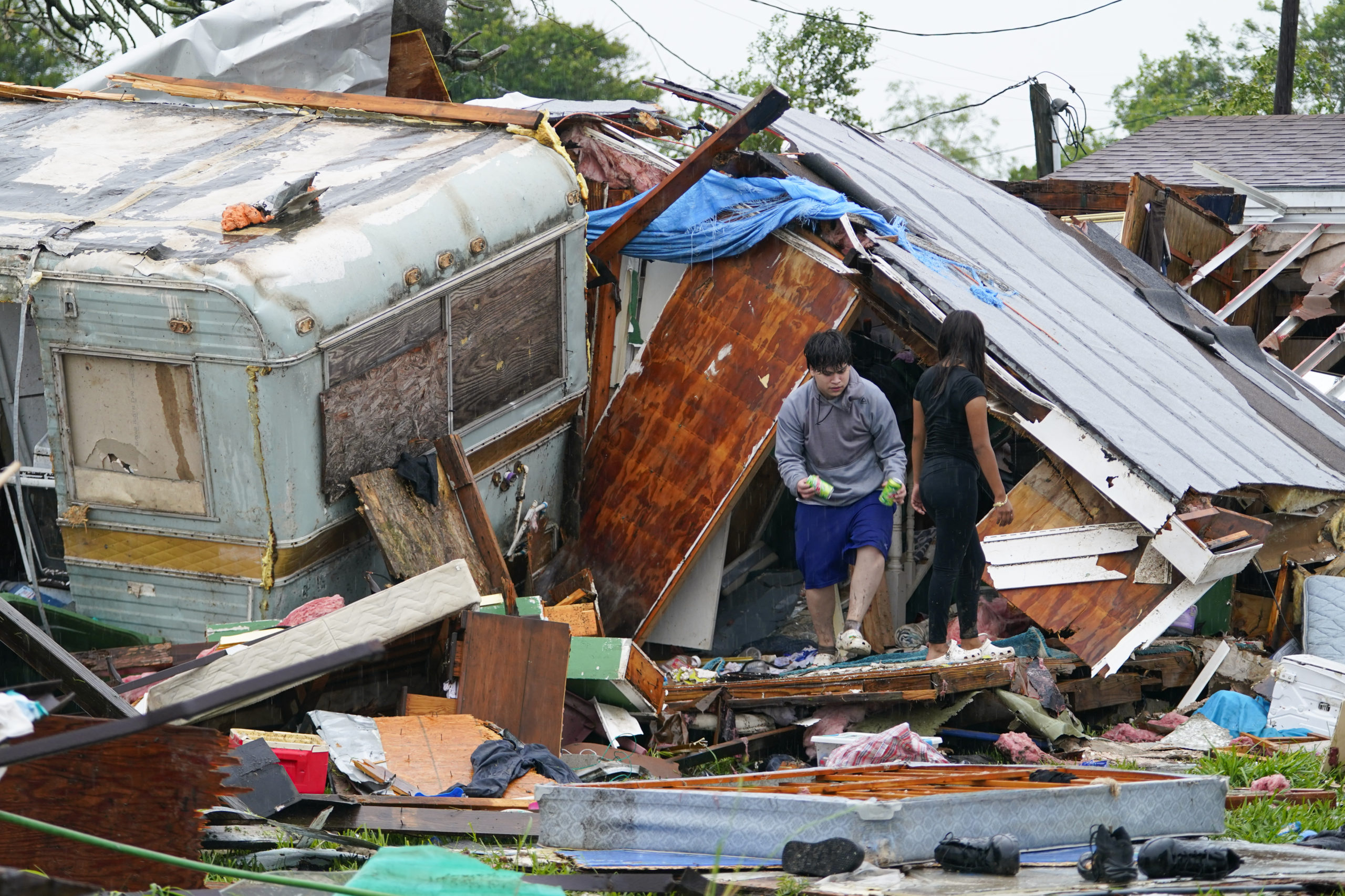 A person stands outside of a damaged home after a tornado hit on Saturday in Laguna Heights, Texas, near South Padre Island. Authorities say one person was killed and several were injured when the tornado struck the southernmost tip of Texas on the Gulf Coast.