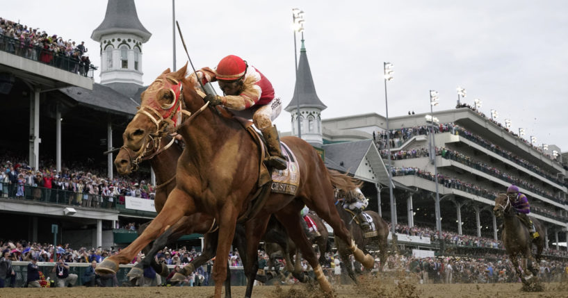 Rich Strike, with Sonny Leon aboard, crosses the finish line to win the 148th running of the Kentucky Derby horse race at Churchill Downs Saturday, May 7, 2022, in Louisville, Kentucky.