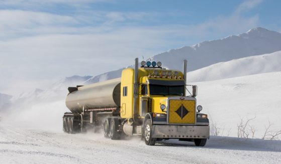 An 18-wheeler moves along the icy and snowy Dalton Highway in the Alaskan wilderness in an undated file photo.