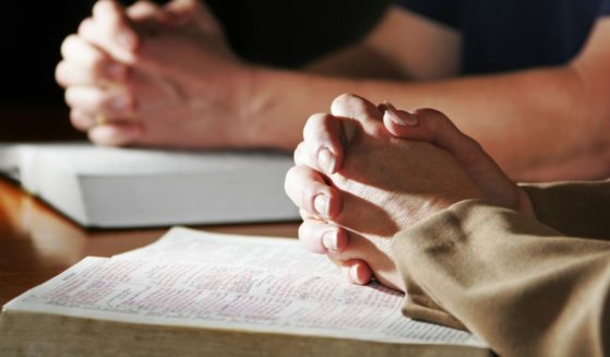 People pray in this stock image.