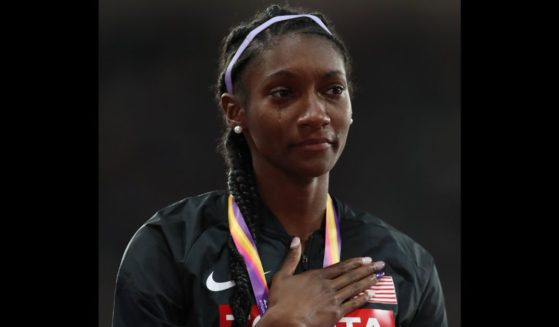 Tori Bowie cries on the podium during the national anthem after winning a gold medal in the women's 4x100m relay final at the 16th IAAF World Athletics Championships in London on Aug. 13, 2017.