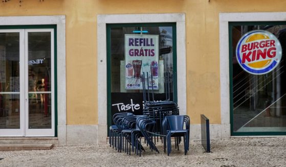 Chairs are stacked up on a sidewalk outside of a Burger King in Lisbon, Portugal, on Nov. 14, 2020.